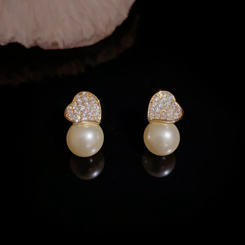 Close-up detail of the sparkling zircons and plating on the gold pearl earrings