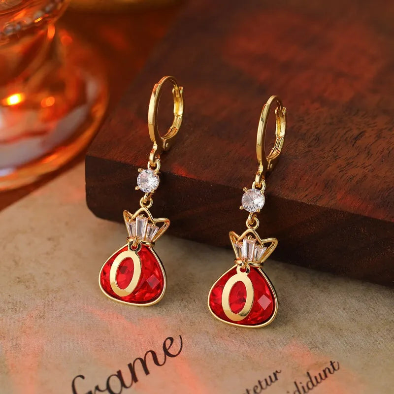 Model showcasing the dangle and style of the 14K Gold-Plated Elegant Zircon Lucky Bag Earrings