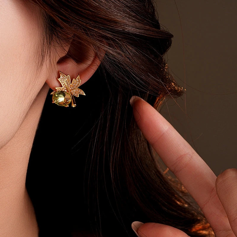 Close-up detail of the sparkling zircons and plating on the gold leaf earrings