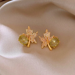 Angled view of the 14K Gold-Plated Elegant Zircon Maple Leaf Diamond Stud Earrings