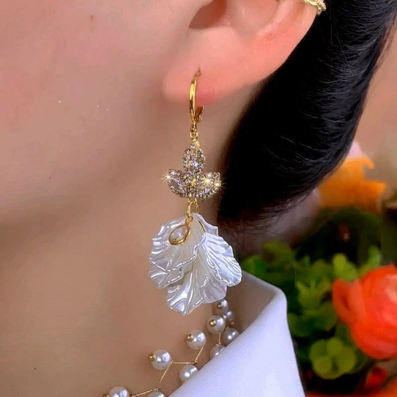 Close-up detail of the sparkling zircons and plating on the gold leaf earrings