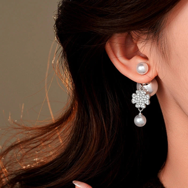 Model showcasing the dangle and style of the 14K Gold-Plated Elegant Zircon Maple Leaf Star Pearl Earrings