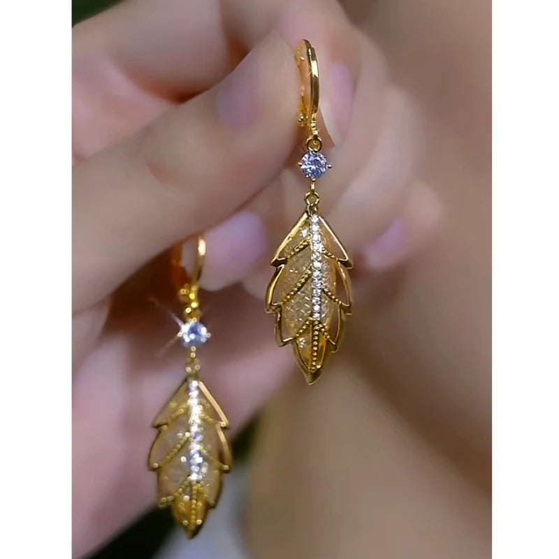 Close-up detail of the sparkling zircons and plating on the gold leaf earrings