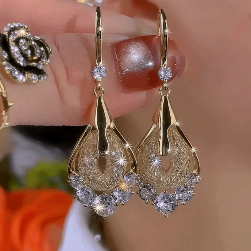 Model showcasing the dangle and style of the 14K Gold-Plated Elegant Zircon Mesh Water Drop Ear Hook Earrings