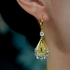 Close-up detail of the sparkling zircons and plating on the gold drop earrings
