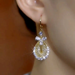 Close-up detail of the sparkling zircons and plating on the gold drop earrings