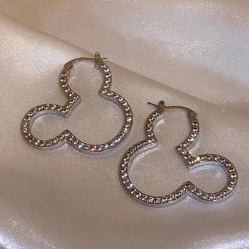 Model showcasing the dangle and style of the 14K Gold-Plated Elegant Zircon Micky Earrings