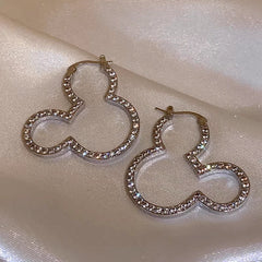 Model showcasing the dangle and style of the 14K Gold-Plated Elegant Zircon Micky Earrings