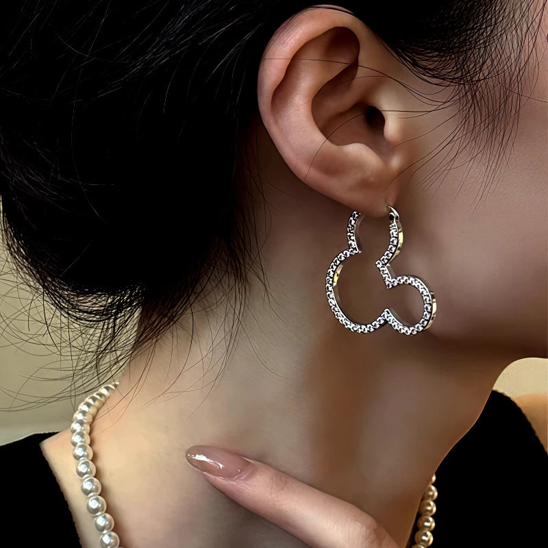 Close-up detail of the sparkling zircons and plating on the gold stud earrings