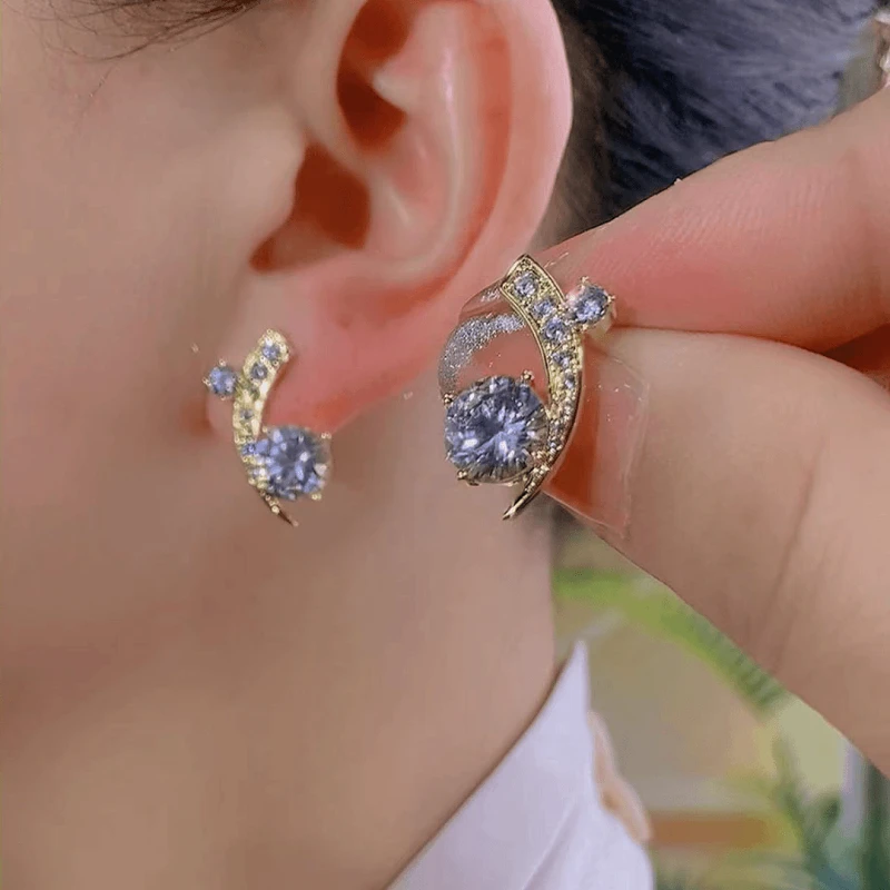 Close-up detail of the sparkling zircons and plating on the gold star earrings