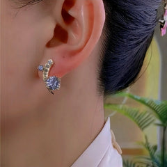 Model showcasing the dangle and style of the 14K Gold-Plated Elegant Zircon Moon Star Stud Earrings