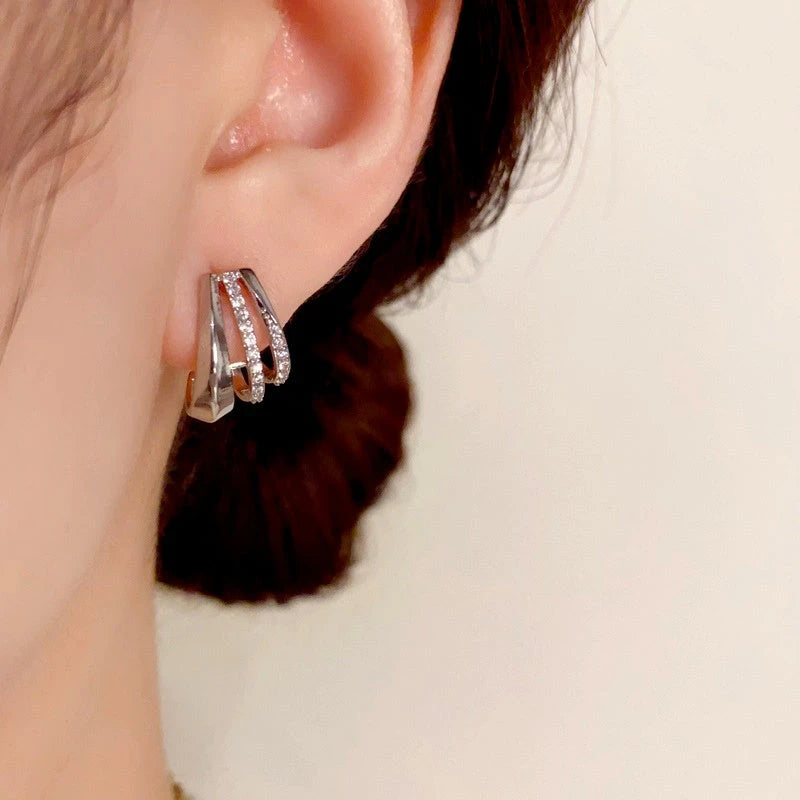 Model showcasing the dangle and style of the 14K Gold-Plated Elegant Zircon Multi-Layer C-Shaped Earrings