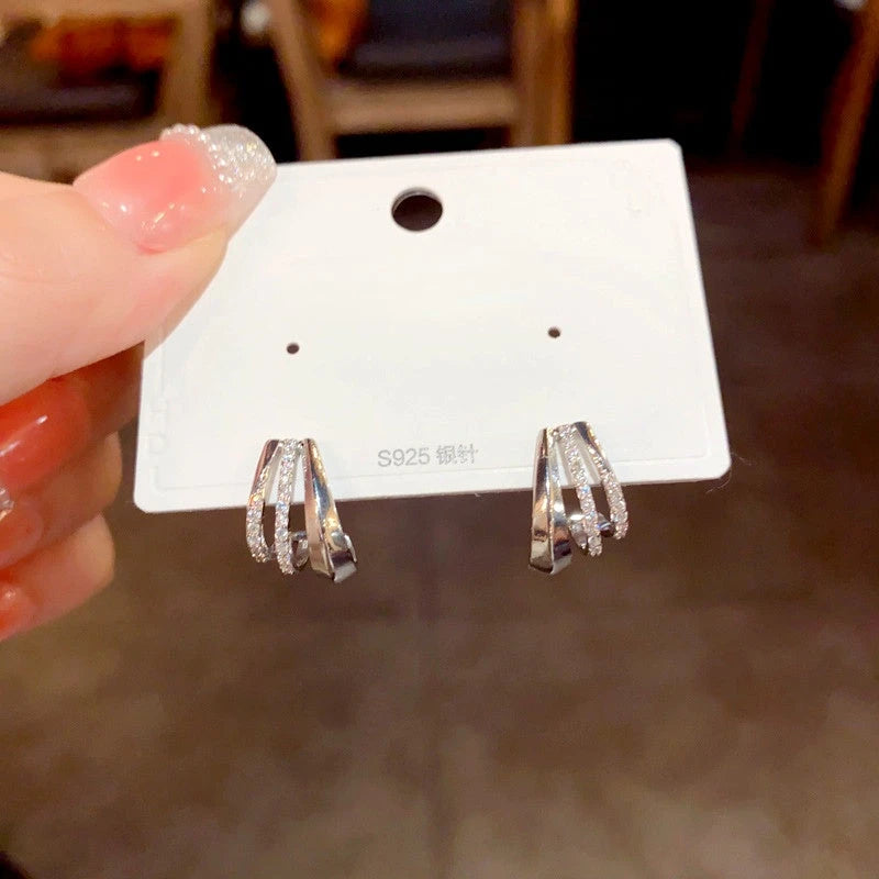 Angled view of the 14K Gold-Plated Elegant Zircon Multi-Layer C-Shaped Earrings