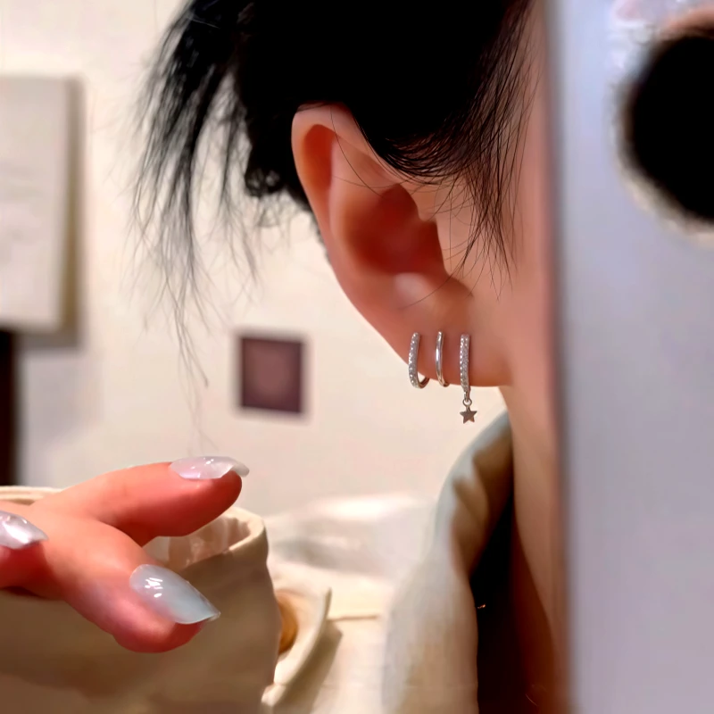 Close-up detail of the sparkling zircons and plating on the silver star earrings