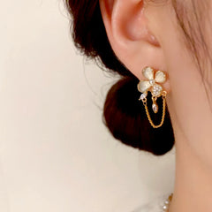 Close-up detail of the sparkling zircons and plating on the gold tassel earrings