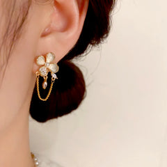 Model showcasing the dangle and style of the 14K Gold-Plated Elegant Zircon Oil Drop Flower Chain Tassel Earrings