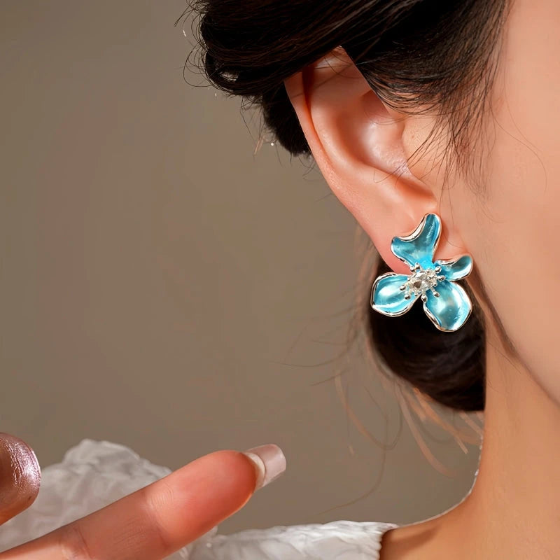 Model showcasing the dangle and style of the 14K Gold-Plated Elegant Zircon Oil Drop Flower Stud Earrings