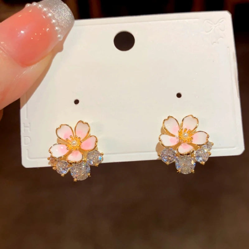 Close-up detail of the sparkling zircons and plating on the gold flower earrings