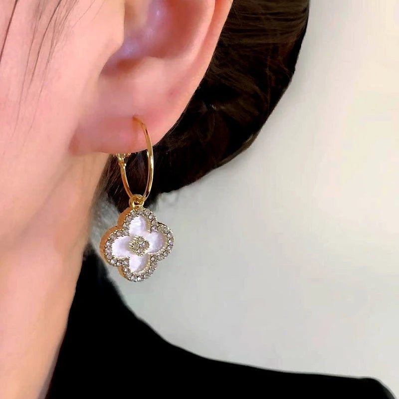 Model showcasing the dangle and style of the 14K Gold-Plated Elegant Zircon Oil Drop Four-Leaf Earrings