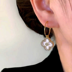 Close-up detail of the sparkling zircons and plating on the clover earrings