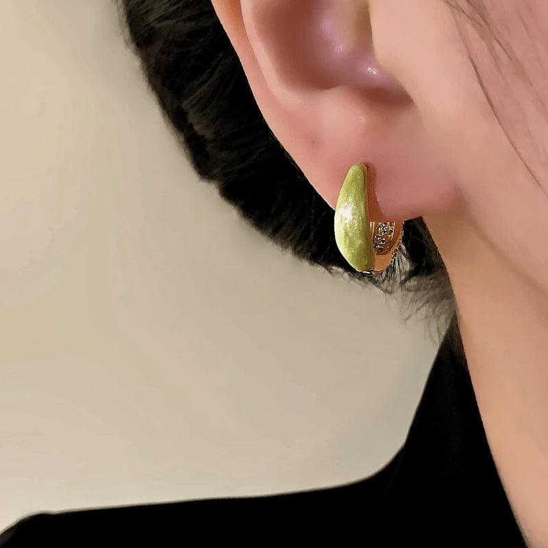 Model showcasing the dangle and style of the 14K Gold-Plated Elegant Zircon Oil Drop Hoop Earrings