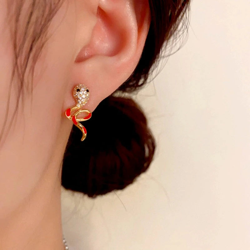 Close-up detail of the sparkling zircons and plating on the gold snake earrings