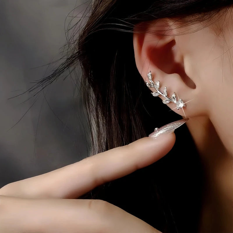 Model showcasing the dangle and style of the 14K Gold-Plated Elegant Zircon Olive Leaf Crawler Earrings