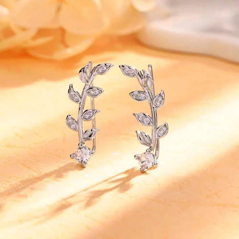 Close-up detail of the sparkling zircons and plating on the silver crawler earrings