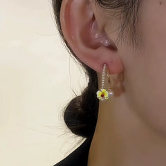 Model showcasing the dangle and style of the 14K Gold-Plated Elegant Zircon Orchid Flower Pearl Earrings