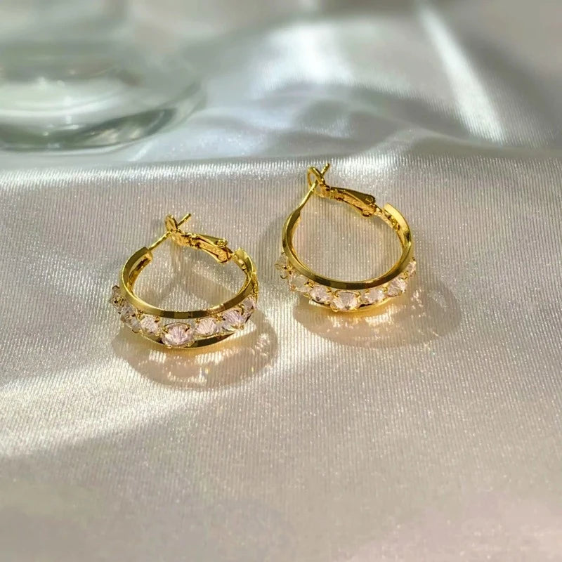 Angled view of the 14K Gold-Plated Elegant Zircon Oval Hoop Earrings