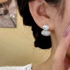 Model showcasing the dangle and style of the 14K Gold-Plated Elegant Zircon Oval Pearl Drop Earrings