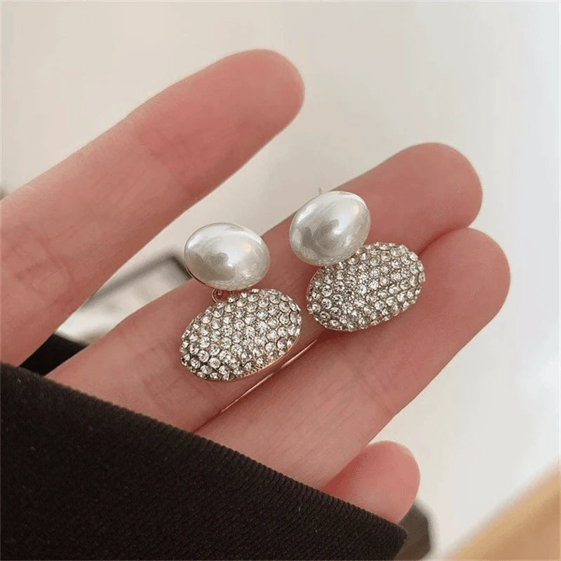 Close-up detail of the sparkling zircons and plating on the silver pearl earrings