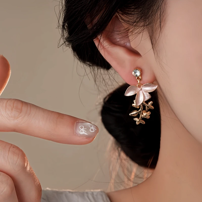 Model showcasing the dangle and style of the 14K Gold-Plated Elegant Zircon Painted Flower Tassel Earrings