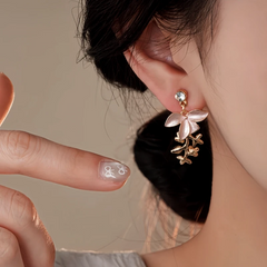 Model showcasing the dangle and style of the 14K Gold-Plated Elegant Zircon Painted Flower Tassel Earrings