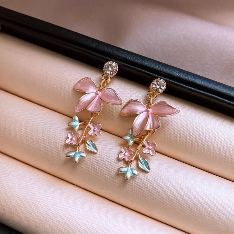 Close-up detail of the sparkling zircons and plating on the gold tassel earrings