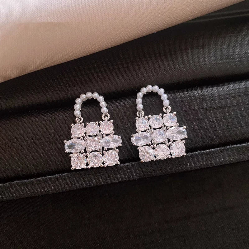 Angled view of the 14K Gold-Plated Elegant Zircon Pearl Bag Earrings