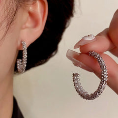 Model showcasing the dangle and style of the 14K Gold-Plated Elegant Zircon Pearl C-Hoop Earrings