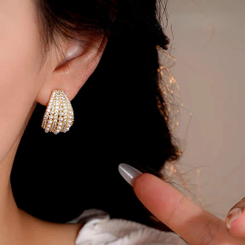 Model showcasing the dangle and style of the 14K Gold-Plated Elegant Zircon Pearl C-Shaped Earrings