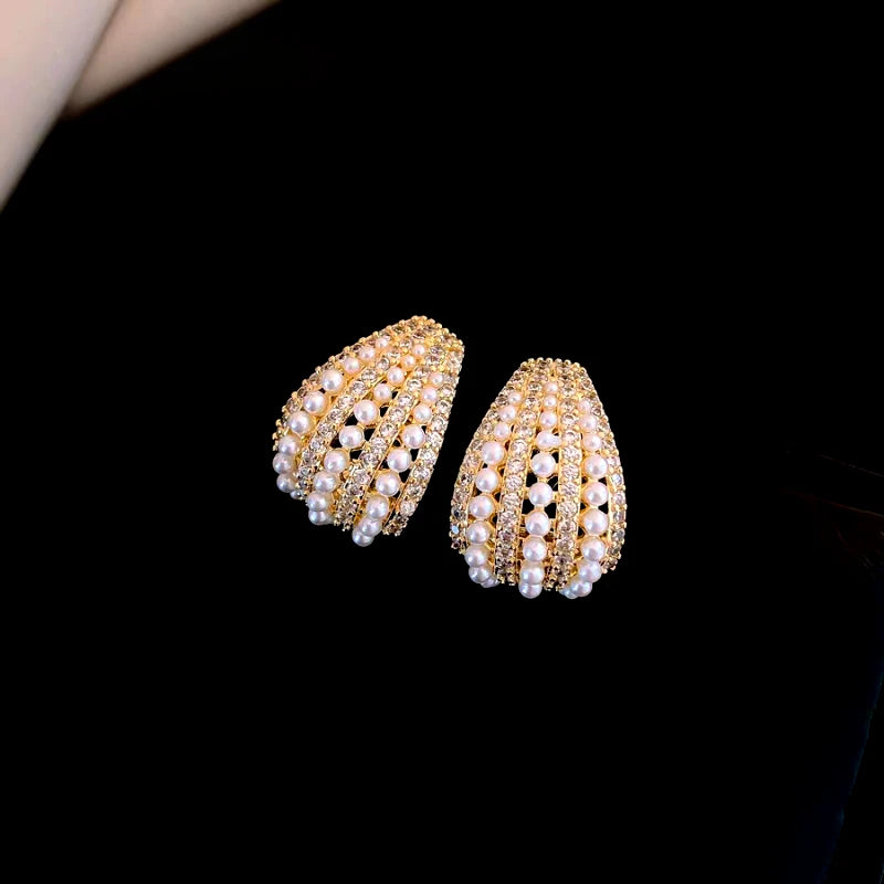 Close-up detail of the sparkling zircons and plating on the gold hoop earrings