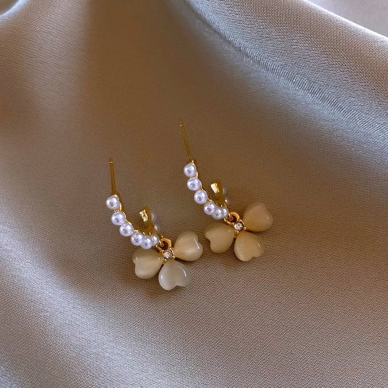 Angled view of the 14K Gold-Plated Elegant Zircon Pearl Cat's Eye Flower Earrings
