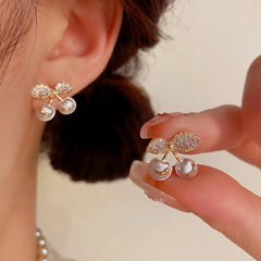 Close-up detail of the sparkling zircons and plating on the gold stud earrings