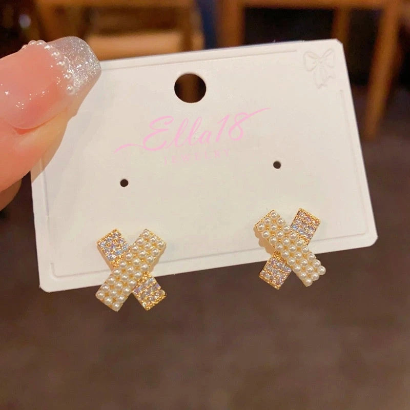 Close-up detail of the sparkling zircons and plating on the gold cross earrings