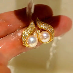 Model showcasing the dangle and style of the 14K Gold-Plated Elegant Zircon Pearl Earrings