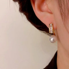 Model showcasing the dangle and style of the 14K Gold-Plated Elegant Zircon Pearl Earrings
