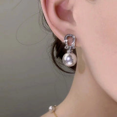 Close-up detail of the sparkling zircons and plating on the silver pearl earrings