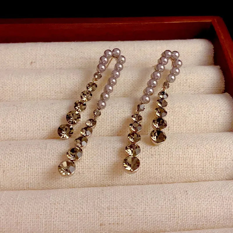 Close-up detail of the sparkling zircons and plating on the gold pearl earrings