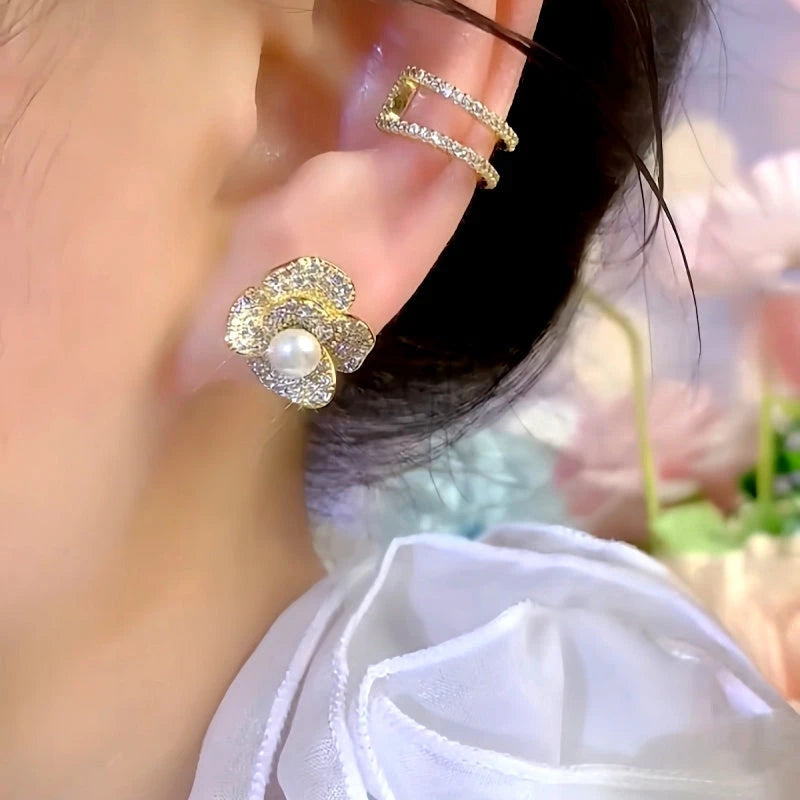 Model showcasing the dangle and style of the 14K Gold-Plated Elegant Zircon Pearl Flower Stud Earrings