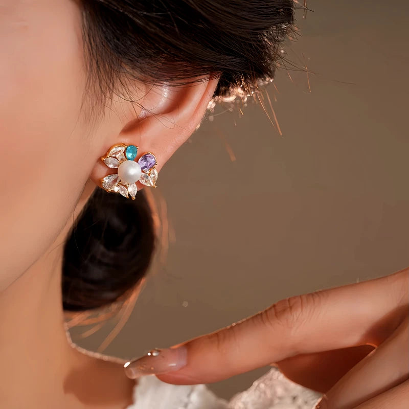 Close-up detail of the sparkling zircons and plating on the gold flower earrings