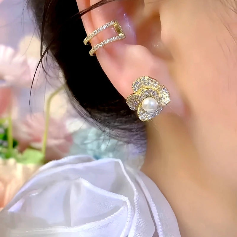 Close-up detail of the sparkling zircons and plating on the gold flower earrings