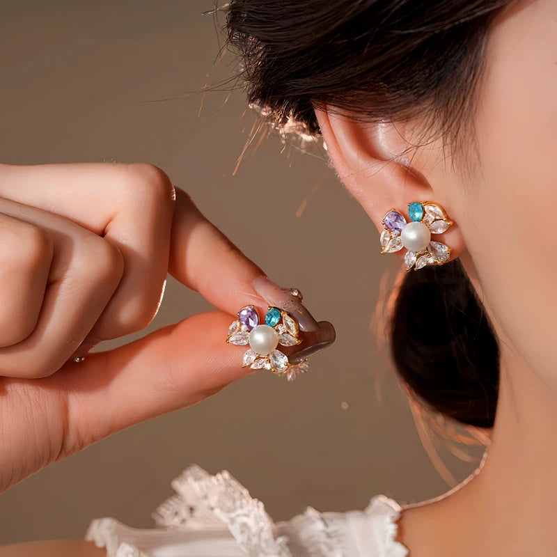 Model showcasing the dangle and style of the 14K Gold-Plated Elegant Zircon Pearl Flower Stud Earrings